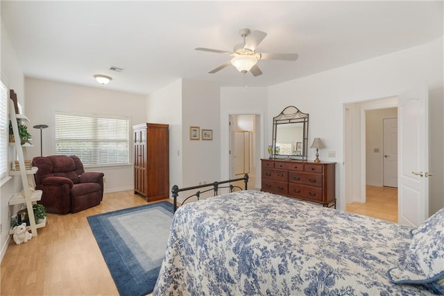 bedroom featuring light wood finished floors, a ceiling fan, baseboards, and visible vents