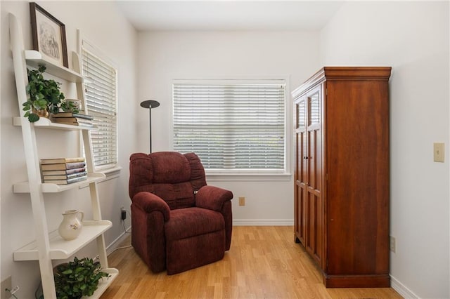 sitting room with light wood finished floors and baseboards