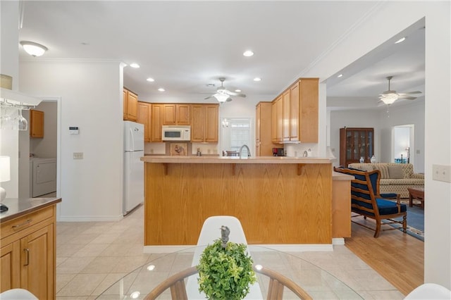 kitchen with recessed lighting, washer / clothes dryer, a ceiling fan, and white appliances