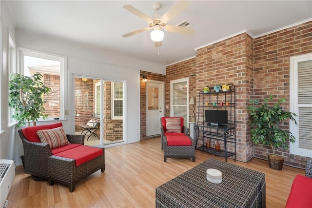 sunroom with ceiling fan, an AC wall unit, and visible vents