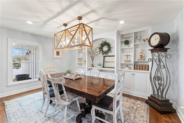 dining room featuring recessed lighting, baseboards, dark wood finished floors, and a textured ceiling