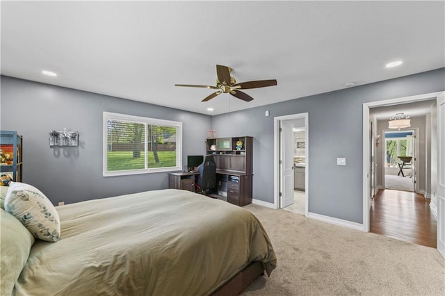 carpeted bedroom with recessed lighting, baseboards, ceiling fan, and ensuite bath