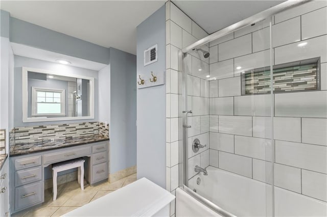 bathroom with tile patterned flooring, vanity, enclosed tub / shower combo, backsplash, and visible vents