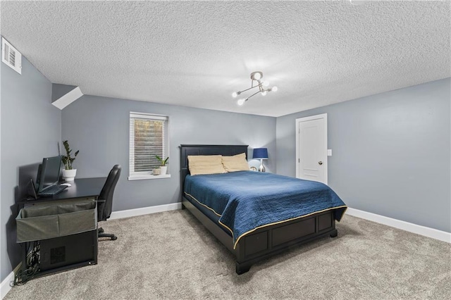 bedroom featuring visible vents, a textured ceiling, carpet, and baseboards