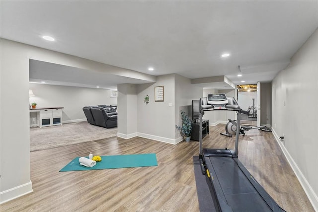 workout room featuring recessed lighting, baseboards, and wood finished floors
