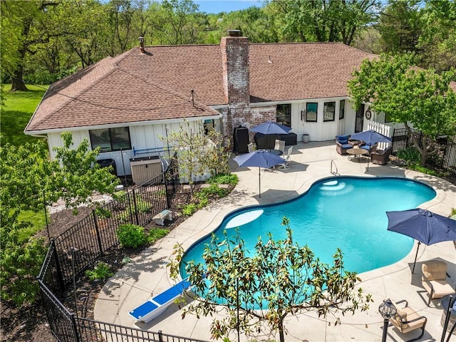 view of swimming pool with a fenced in pool, a fenced backyard, and a patio area