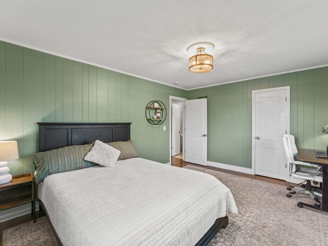 carpeted bedroom featuring baseboards and ornamental molding
