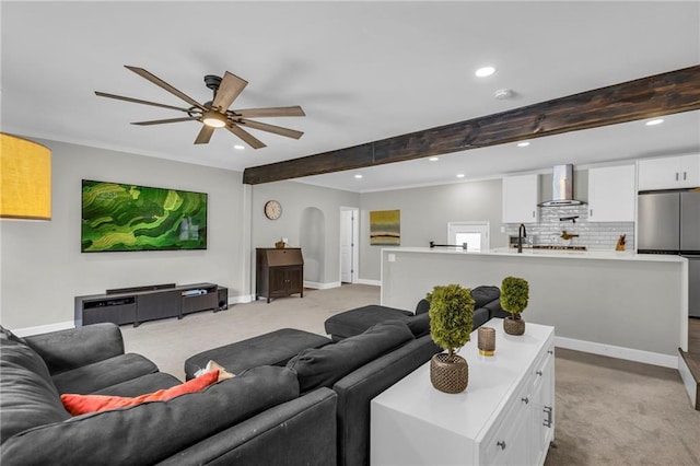 living room featuring light carpet, recessed lighting, a ceiling fan, baseboards, and beam ceiling
