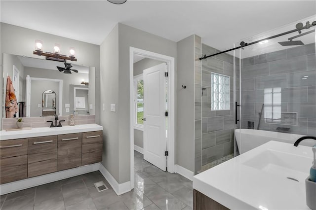 bathroom with a shower stall, healthy amount of natural light, vanity, and a chandelier