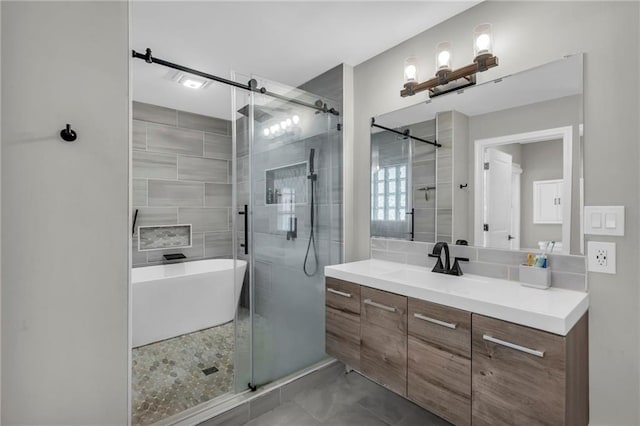 bathroom featuring a shower stall, vanity, and a freestanding bath