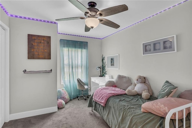 carpeted bedroom featuring baseboards and ceiling fan