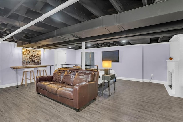 living room with baseboards and wood finished floors