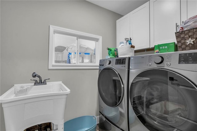 washroom featuring washing machine and clothes dryer and cabinet space