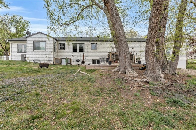 rear view of property with a lawn