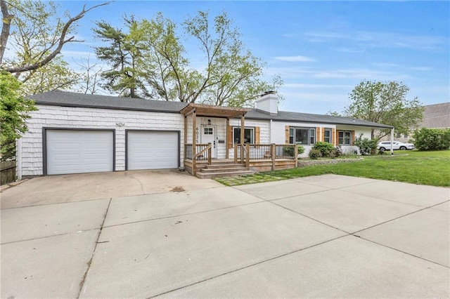 ranch-style home with driveway, an attached garage, a front yard, and a chimney