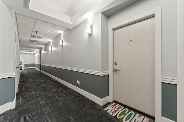 308 W 8th St Unit 505, Kansas City, MO 64105 - corridor featuring baseboards, dark colored carpet, and a paneled ceiling