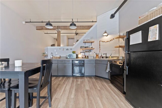 308 W 8th St Unit 505, Kansas City, MO 64105 - kitchen with a sink, open shelves, light wood finished floors, gray cabinetry, and black appliances