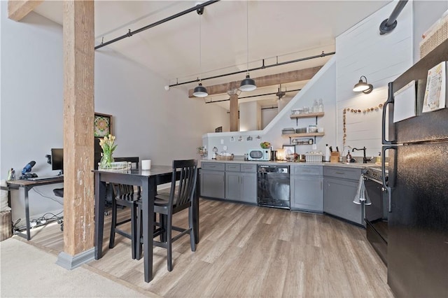 308 W 8th St Unit 505, Kansas City, MO 64105 - kitchen featuring light wood finished floors, gray cabinetry, black appliances, and open shelves