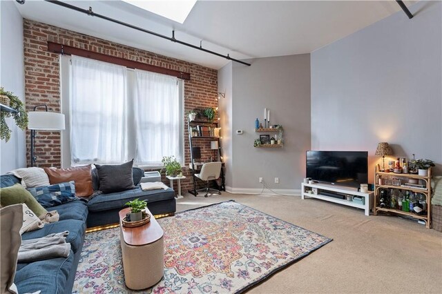 308 W 8th St Unit 505, Kansas City, MO 64105 - carpeted living room with baseboards and brick wall