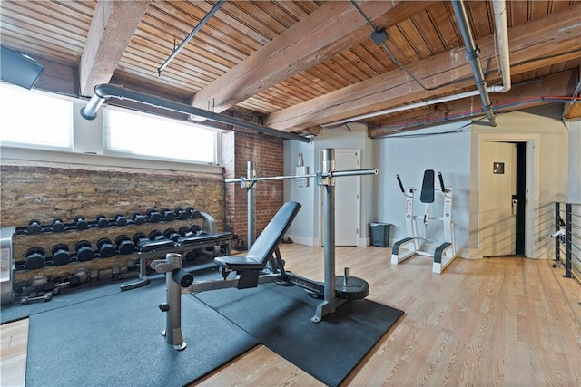 308 W 8th St Unit 505, Kansas City, MO 64105 - exercise room featuring wood ceiling, brick wall, and wood finished floors