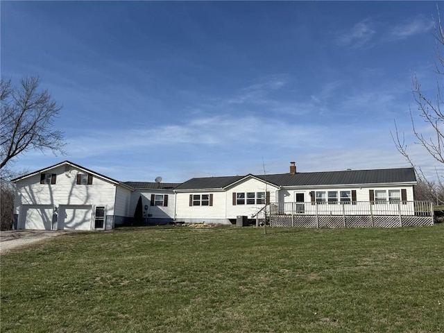 7538 NW 356th St, Stewartsville, MO 64490 - rear view of property featuring a deck, a garage, a yard, and a chimney