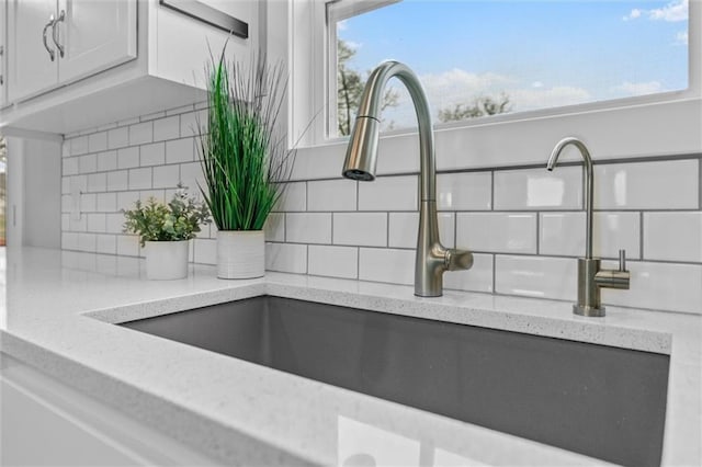200 NW 180th St, Smithville, MO 64089 - detailed view of a sink, backsplash, white cabinets, and light stone countertops