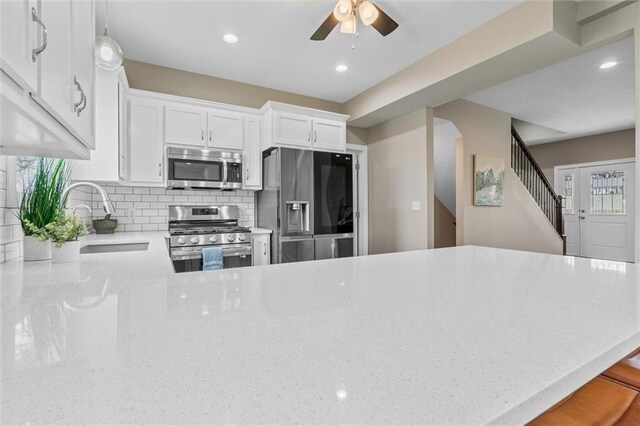 200 NW 180th St, Smithville, MO 64089 - kitchen with stainless steel appliances, a sink, a ceiling fan, light stone counters, and recessed lighting