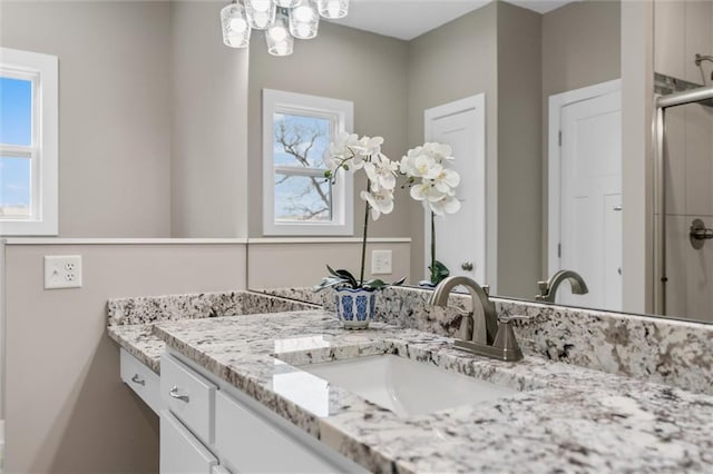 200 NW 180th St, Smithville, MO 64089 - full bathroom featuring vanity, healthy amount of natural light, a shower stall, and a chandelier