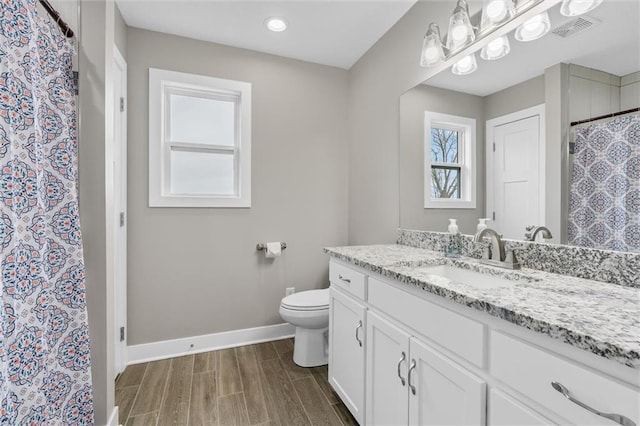 200 NW 180th St, Smithville, MO 64089 - full bath with baseboards, toilet, wood finished floors, vanity, and recessed lighting