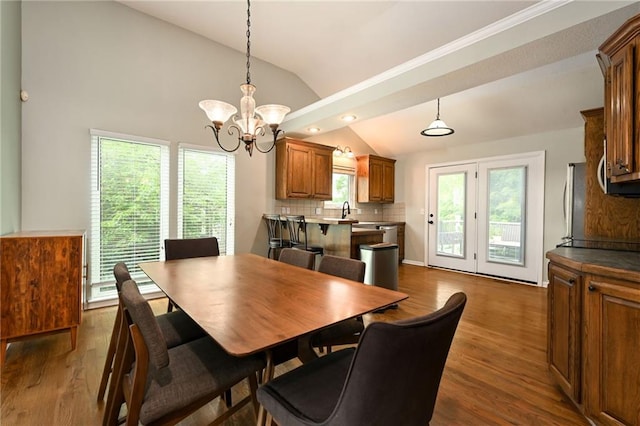1216 SE Meridian Dr, Lees Summit, MO 64081 - dining area featuring vaulted ceiling, a chandelier, and dark wood-style floors