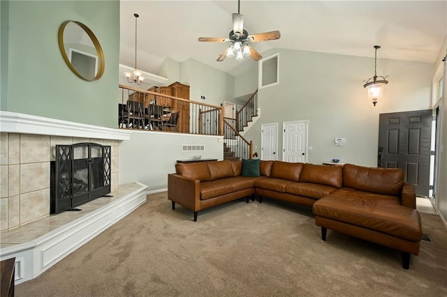 1216 SE Meridian Dr, Lees Summit, MO 64081 - living area with carpet flooring, high vaulted ceiling, stairs, a ceiling fan, and a tile fireplace