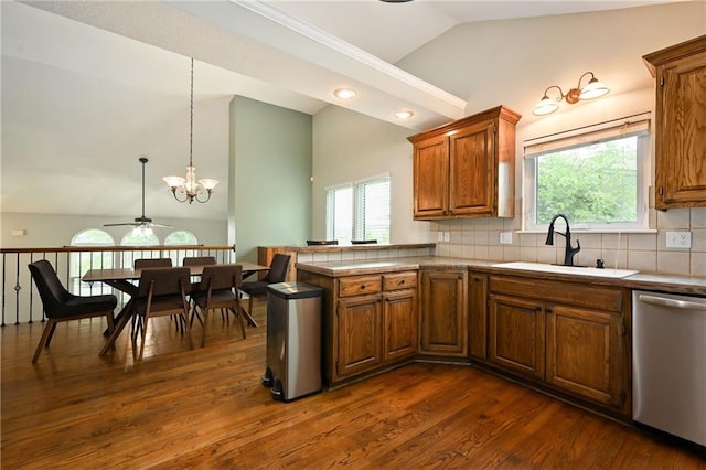 1216 SE Meridian Dr, Lees Summit, MO 64081 - kitchen featuring dishwasher, a sink, brown cabinets, a peninsula, and dark wood-style floors