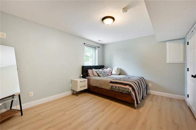 1216 SE Meridian Dr, Lees Summit, MO 64081 - bedroom featuring light wood-style floors and baseboards