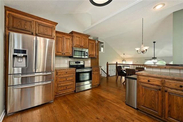 1216 SE Meridian Dr, Lees Summit, MO 64081 - kitchen with stainless steel appliances, lofted ceiling, decorative backsplash, dark countertops, and brown cabinets
