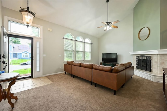 1216 SE Meridian Dr, Lees Summit, MO 64081 - carpeted living area featuring plenty of natural light, ceiling fan, a fireplace, tile patterned floors, and high vaulted ceiling