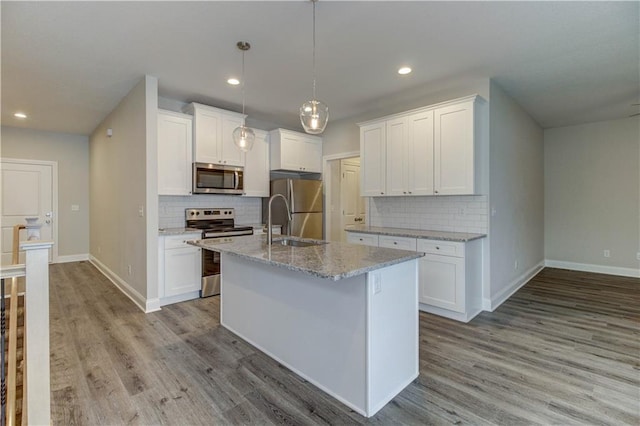 kitchen featuring white cabinetry, light wood-style flooring, and stainless steel appliances