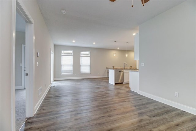 unfurnished living room featuring baseboards, visible vents, wood finished floors, and recessed lighting