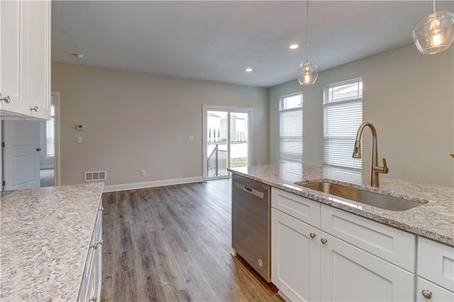 kitchen featuring decorative light fixtures, a sink, dishwasher, white cabinets, and wood finished floors