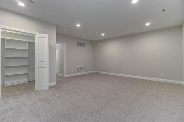interior space with light colored carpet, visible vents, and recessed lighting