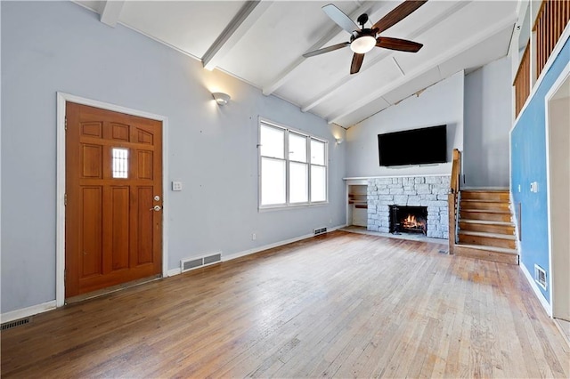 unfurnished living room with light wood-style flooring, visible vents, beam ceiling, and ceiling fan
