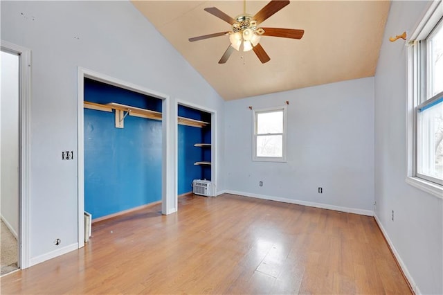 interior space with a ceiling fan, wood finished floors, and plenty of natural light