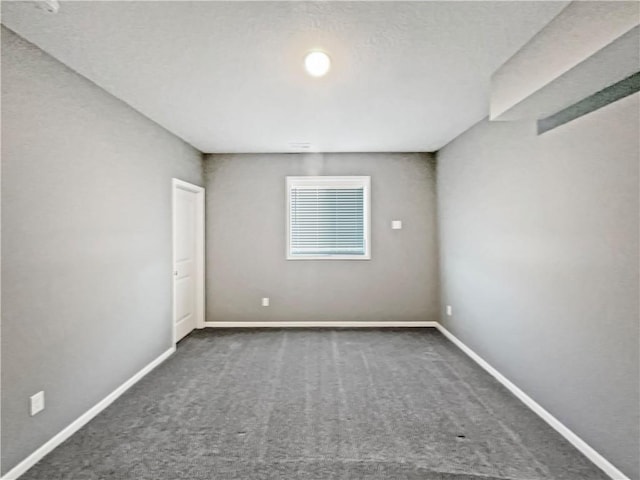carpeted empty room with baseboards