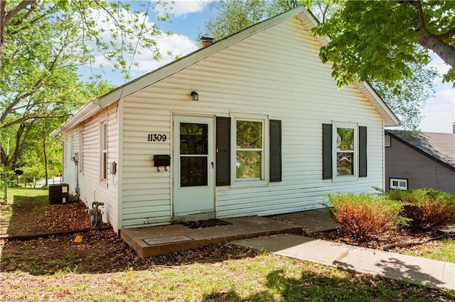 rear view of property with central air condition unit