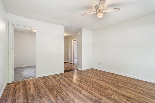 unfurnished room featuring wood finished floors, baseboards, and a ceiling fan