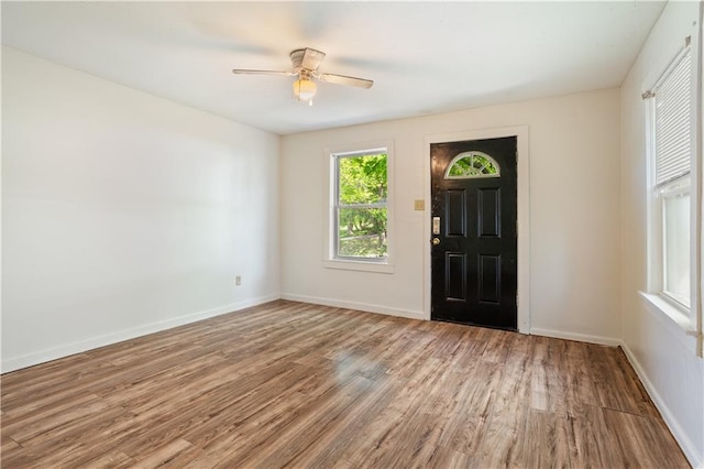 entryway with baseboards, ceiling fan, and wood finished floors
