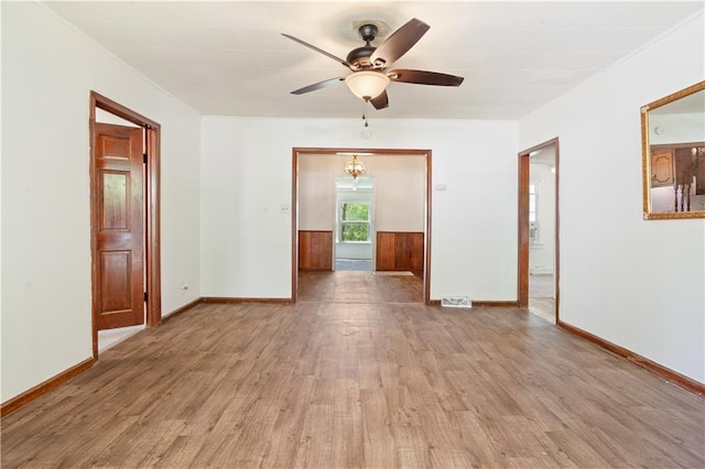 unfurnished room with light wood-type flooring, visible vents, baseboards, and ceiling fan