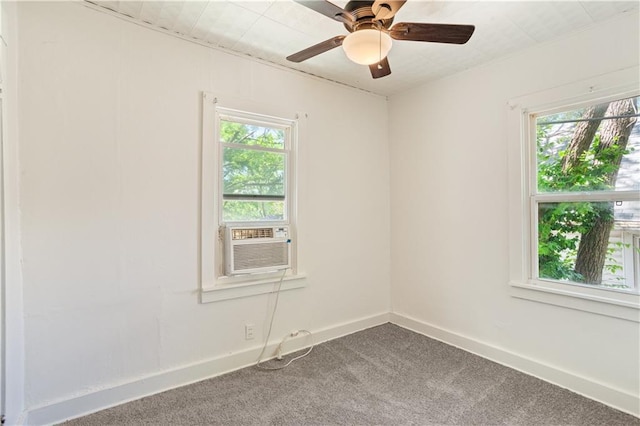 unfurnished room with ceiling fan, carpet flooring, baseboards, and cooling unit