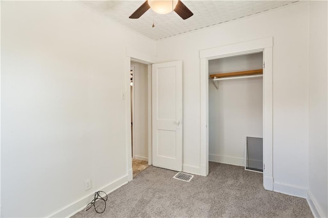 unfurnished bedroom with light colored carpet, visible vents, baseboards, and ceiling fan