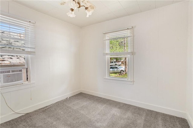 empty room with cooling unit, carpet floors, and baseboards