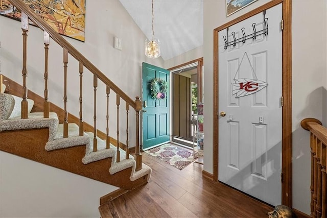 9111 Allman Rd, Lenexa, KS 66219 - entrance foyer with dark wood finished floors, stairs, high vaulted ceiling, and a chandelier